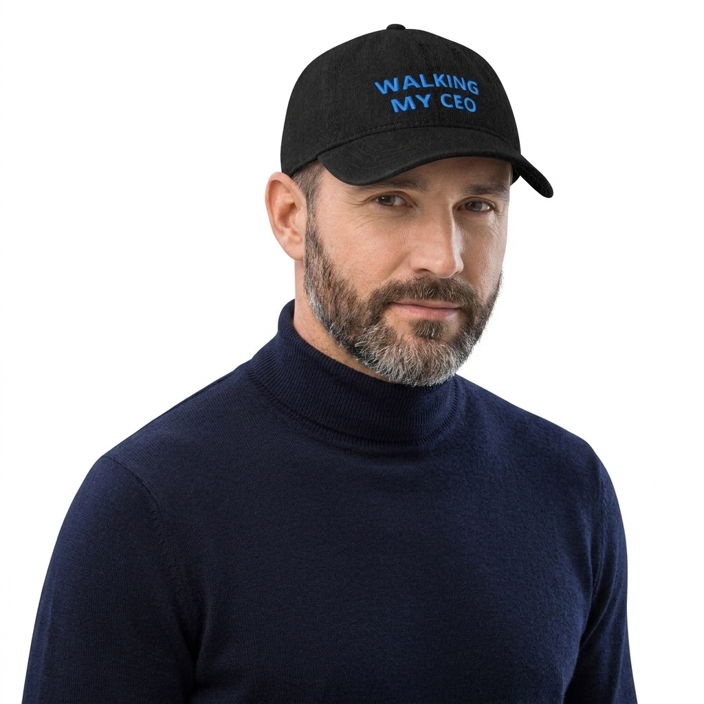 A man wearing a black baseball cap with blue embroidered text reading 'WALKING MY CEO' and a dark navy turtleneck sweater, photographed against a plain white background.