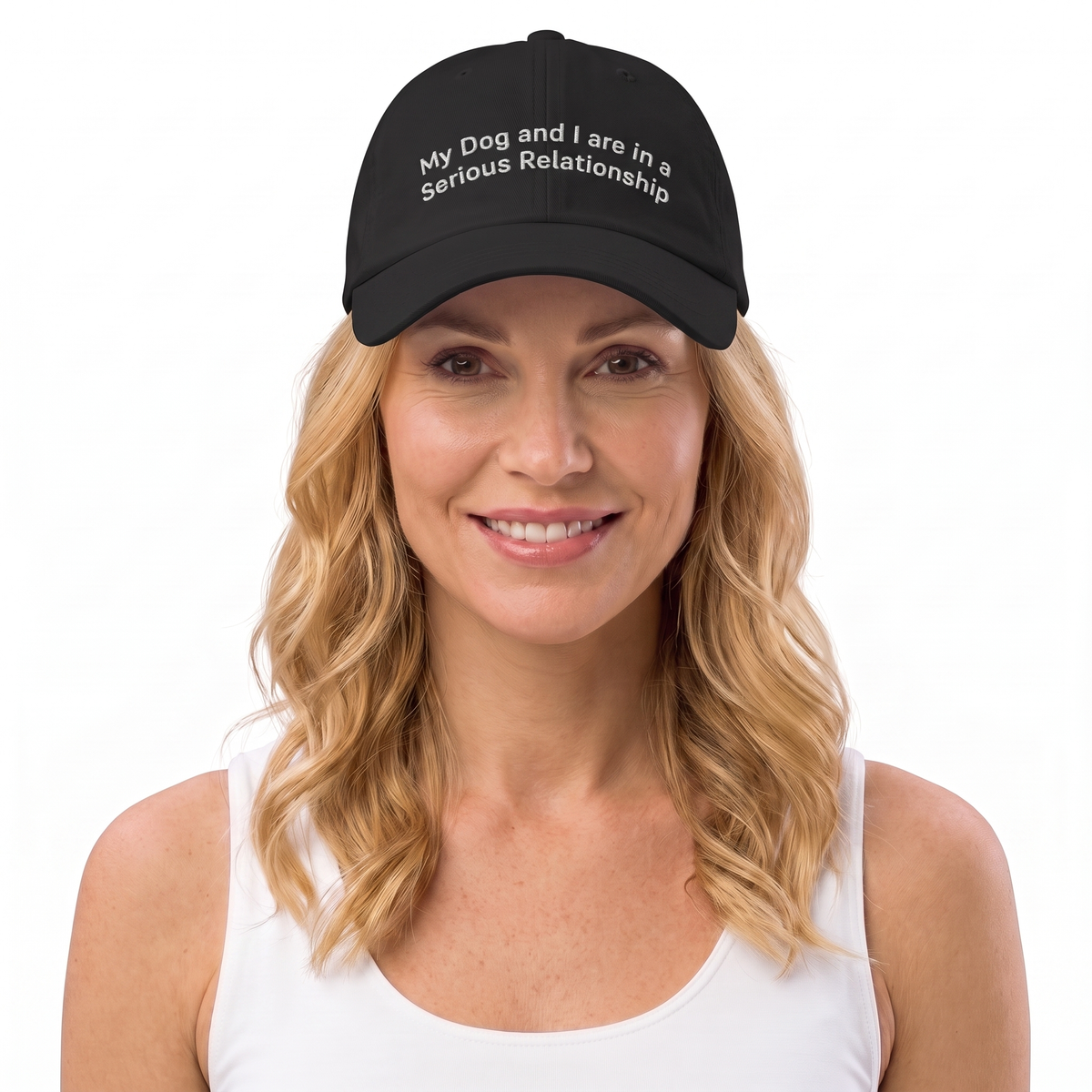 A woman with blonde hair wearing a black baseball cap with white embroidered text that reads 'My Dog and I are in a Serious Relationship' against a plain white background.