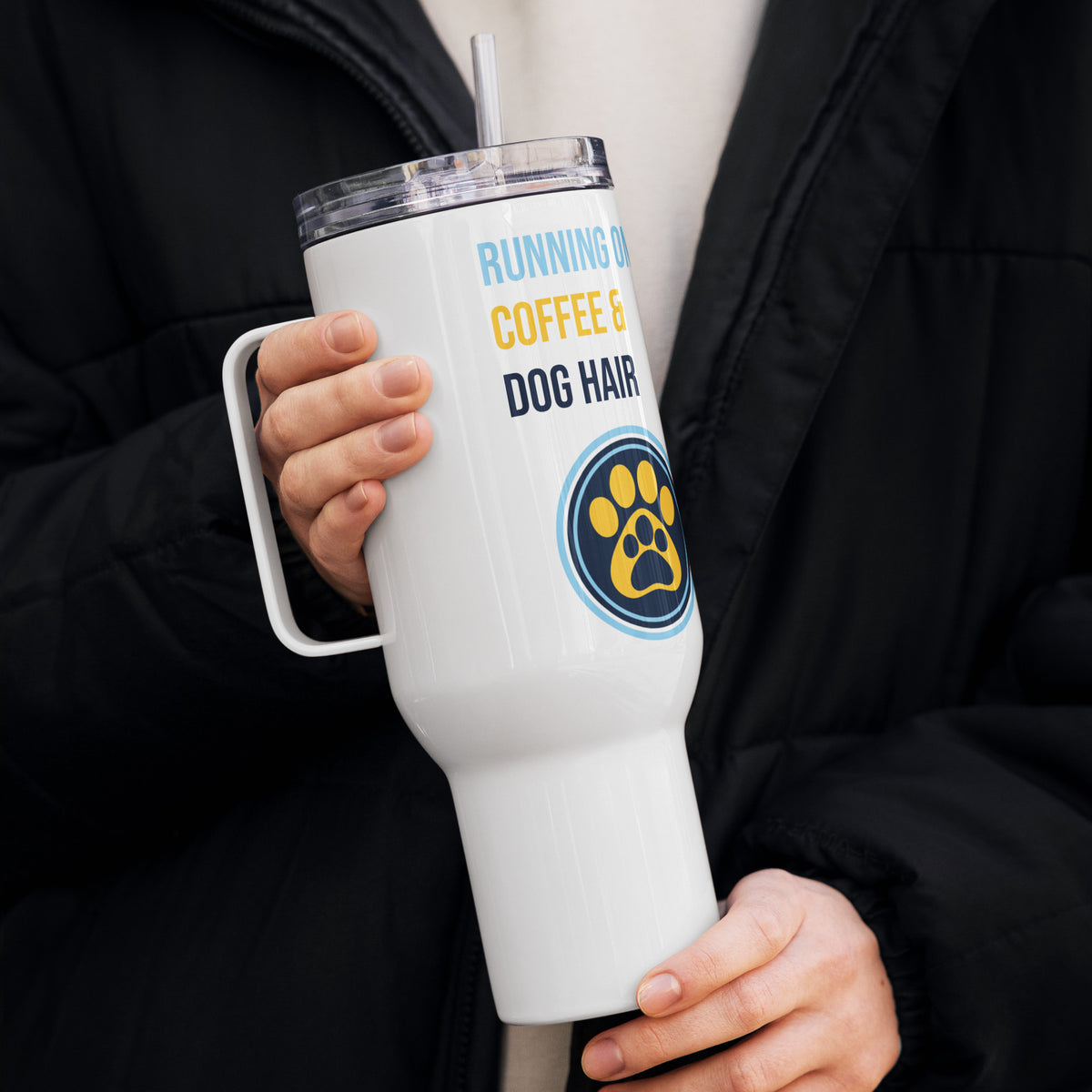 Human keeping a white tumbler with text 'Running on Coffee & Dog Hair' and a paw print design on a white background